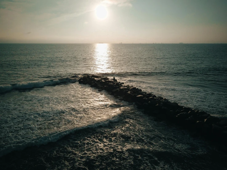 the sun is setting over a body of water, a picture, pexels contest winner, oceanside, midday sunlight, chillhop, sea foam