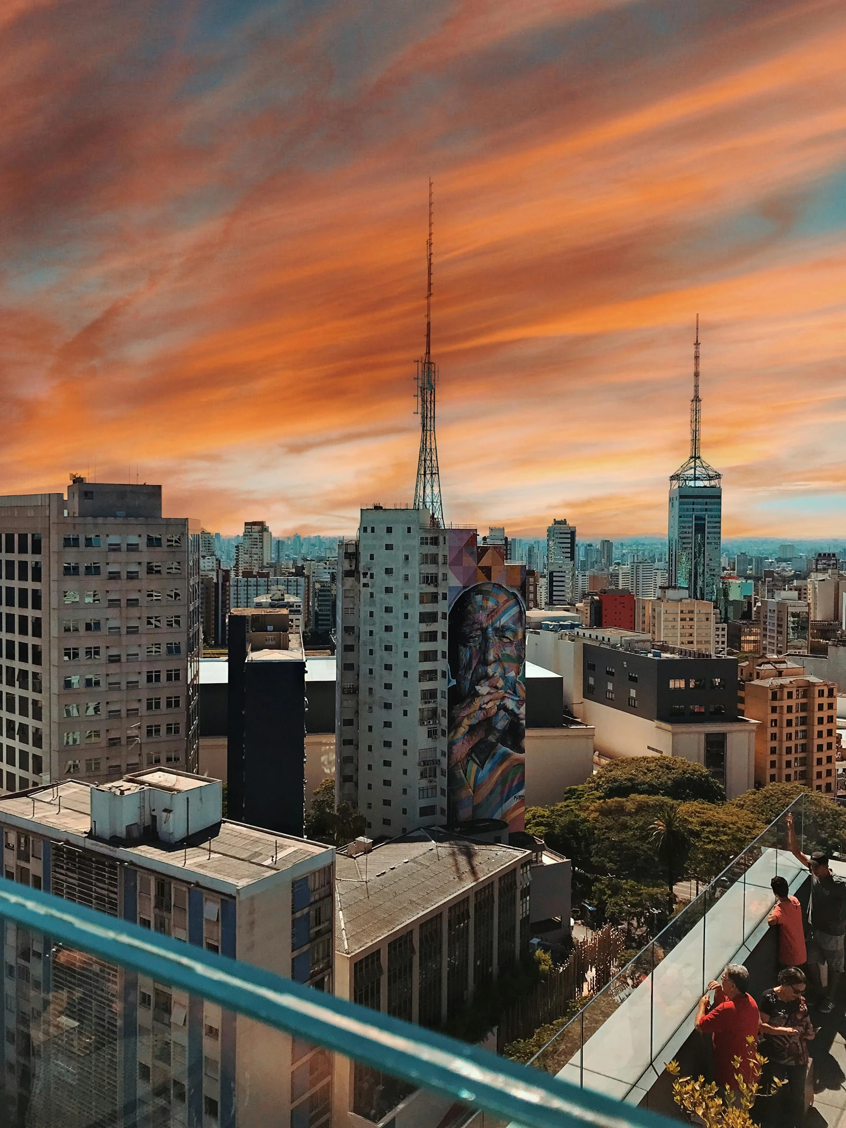 a view of a city from the top of a building, futuristic sao paulo, orange and blue sky, profile pic, uploaded