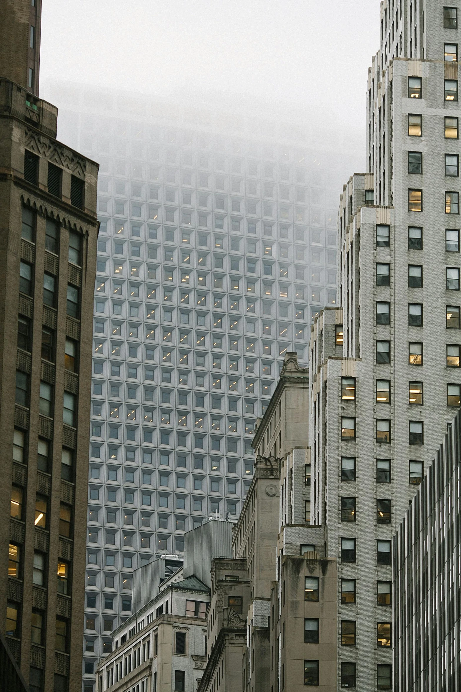 a city street filled with lots of tall buildings, by Greg Rutkowski, pexels contest winner, modernism, grey mist, mies van der rohe, panels, taken in 1 9 9 7