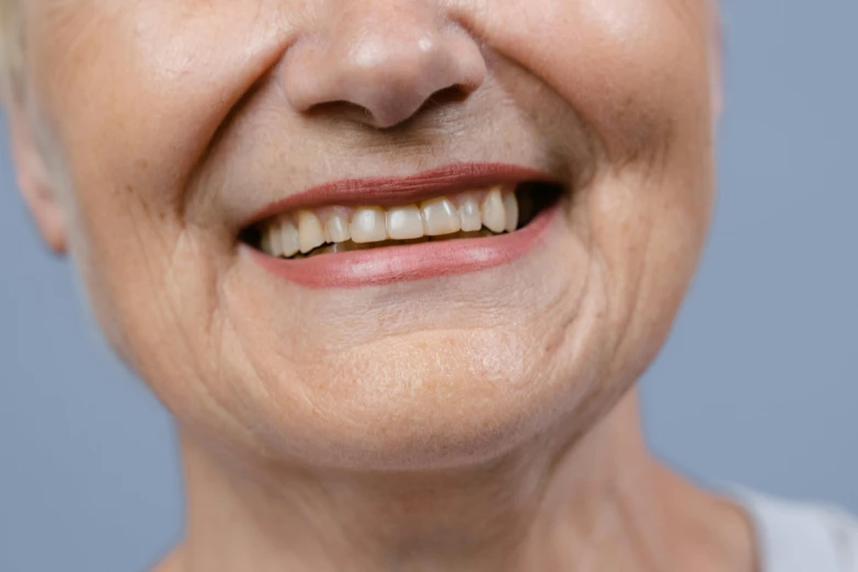 a close up of a person with a tooth brush, profile image, wrinkly, brown, short smile
