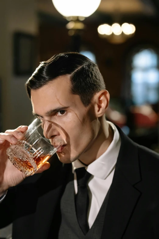 a man in a suit drinking from a glass, an album cover, inspired by F. Scott Hess, renaissance, close-up shoot, 1 9 2 0's style speakeasy, promo image, slicked back hair