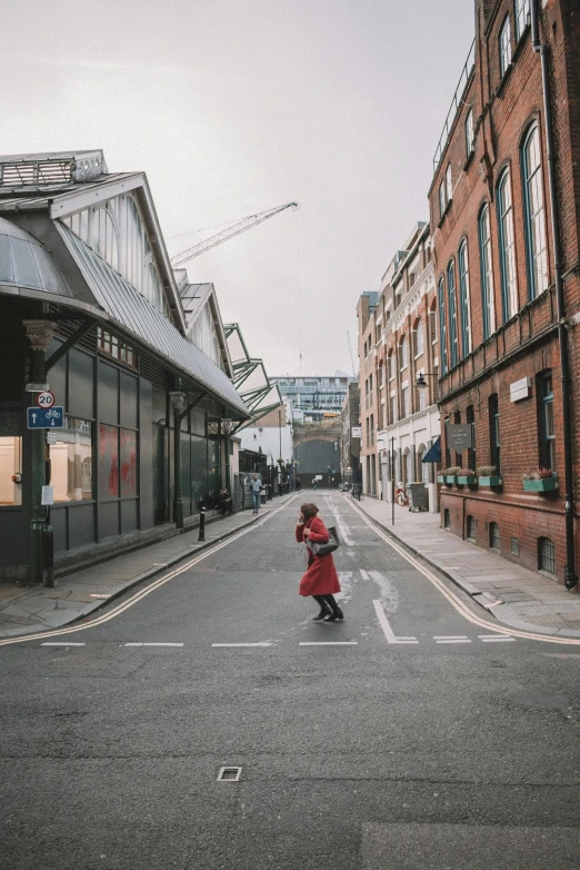 a woman in a red coat walking down a street, by Nina Hamnett, pexels contest winner, london architecture, little kid, market, empty metropolitan street