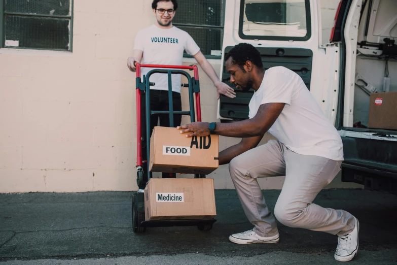 two men unloading boxes from a moving truck, by Francis Helps, pexels contest winner, first aid kit, avatar image, ian david soar, riyahd cassiem