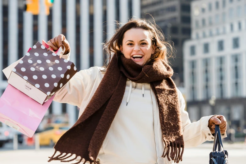 a woman holding shopping bags on a city street, pexels contest winner, happening, all overly excited, brown, graphic print, winter season