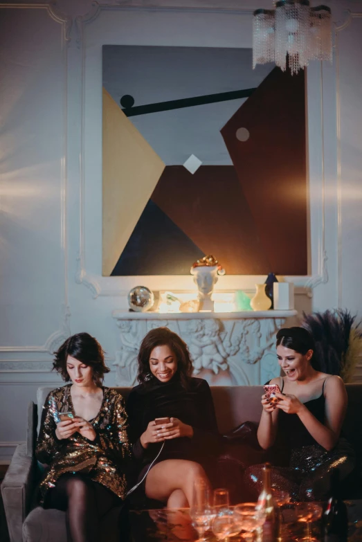 a group of women sitting on top of a couch, inspired by Nan Goldin, trending on pexels, art nouveau, checking her phone, scene from a dinner party, promotional image, portrait photo