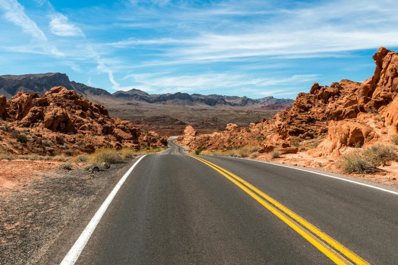 an empty road in the desert with mountains in the background, by Julia Pishtar, pexels contest winner, red sandstone natural sculptures, copper veins, thumbnail, holiday season