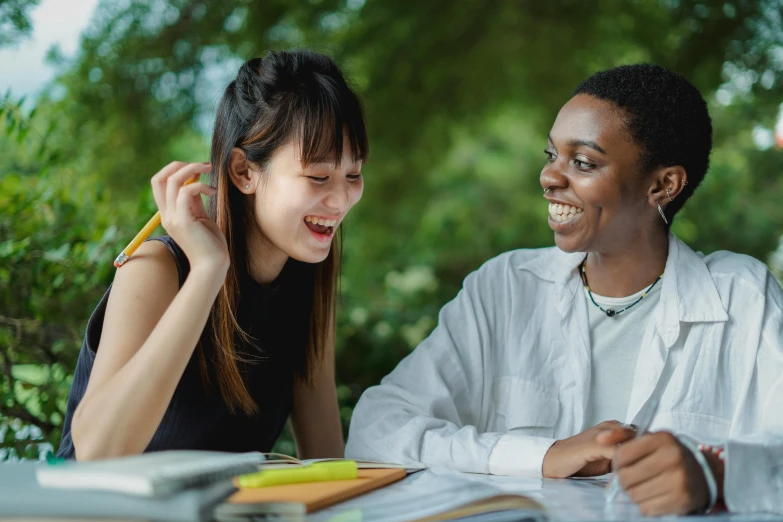 a couple of people that are sitting at a table, trending on pexels, academic art, black teenage girl, ethnicity : japanese, giggling, professional image