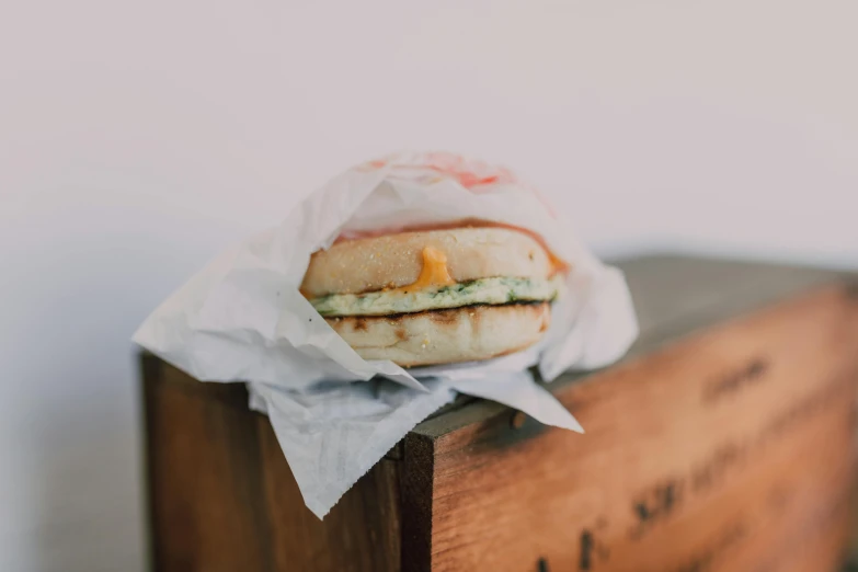 a sandwich sitting on top of a wooden box, unsplash, green eggs and ham, bao phan, 90's photo, background image