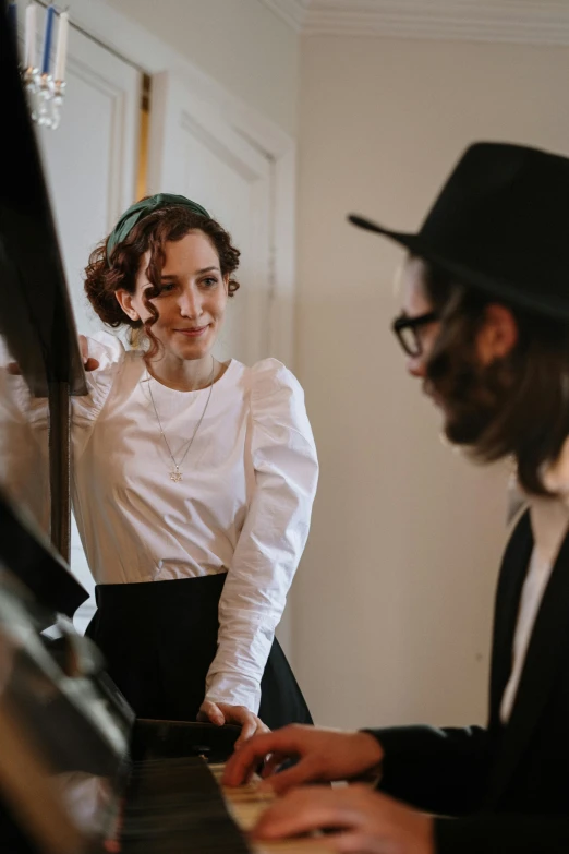 a man and a woman playing a piano, jewish young man with glasses, looking in the mirror, 2019 trending photo, wearing correct era clothes