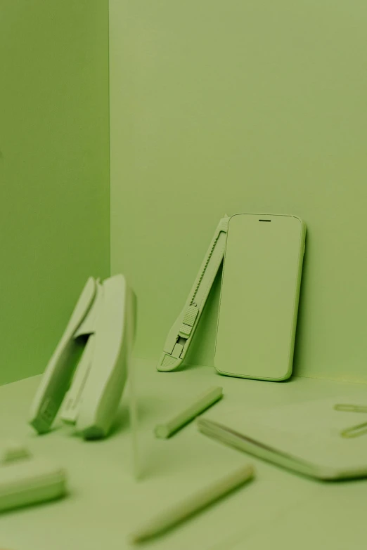 a desktop computer sitting on top of a desk, a still life, by Jang Seung-eop, trending on pexels, conceptual art, pastel green, cell phones, a folding knife, cell cover style