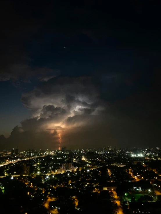 lightning in the sky over a city at night, by Alejandro Obregón, pexels contest winner, happening, ☁🌪🌙👩🏾, colombo sri lanka cityscape, looking towards camera, an atom bomb explosion in mumbai