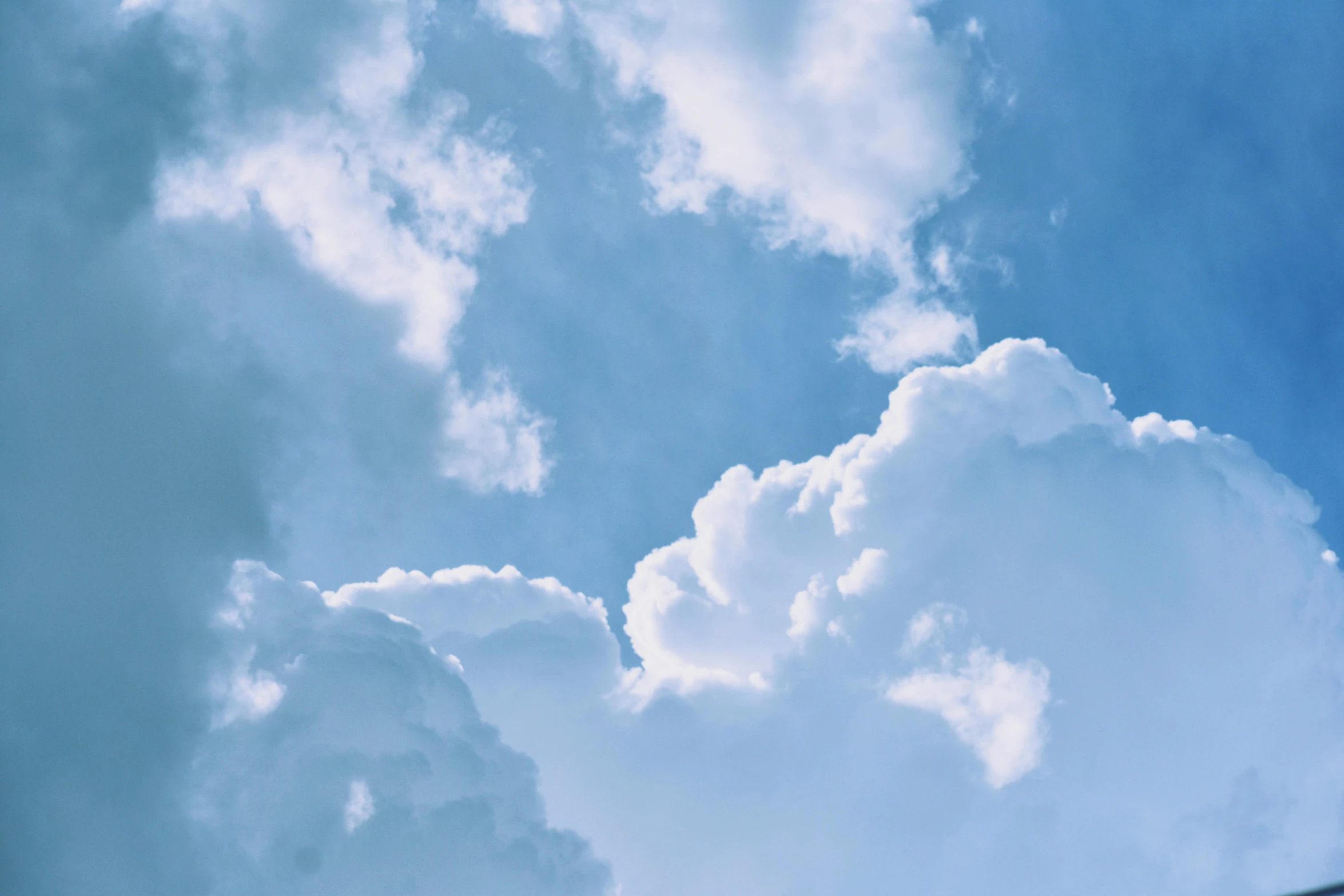 a jetliner flying through a cloudy blue sky, by Carey Morris, pexels contest winner, romanticism, cumulus clouds, looking upwards, cotton candy clouds, light blues