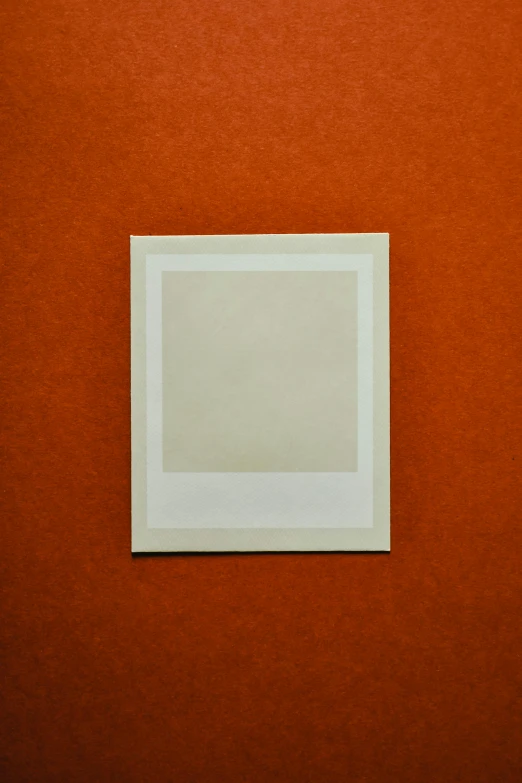a white picture frame sitting on top of an orange wall, a polaroid photo, by James Morris, unsplash, brown paper, square, 15081959 21121991 01012000 4k, paper texture