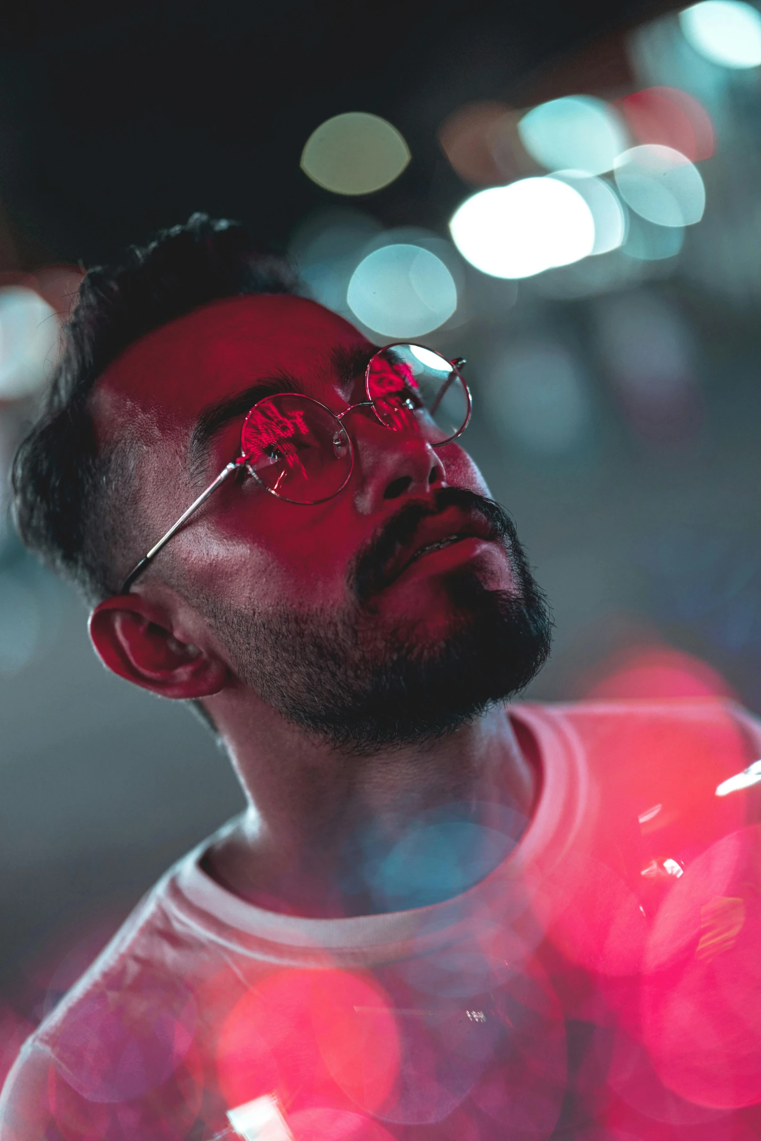 a man standing in the middle of a street at night, an album cover, trending on pexels, wearing red tainted glasses, a portrait of rahul kohli, bisexual lighting, colorful lenses