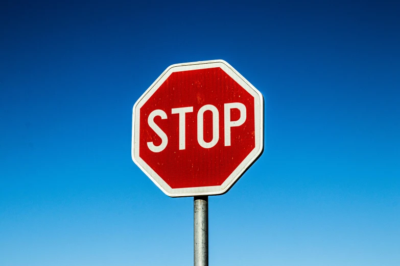 a red stop sign sitting on top of a metal pole, pexels, visual art, square, blue, holding close, english