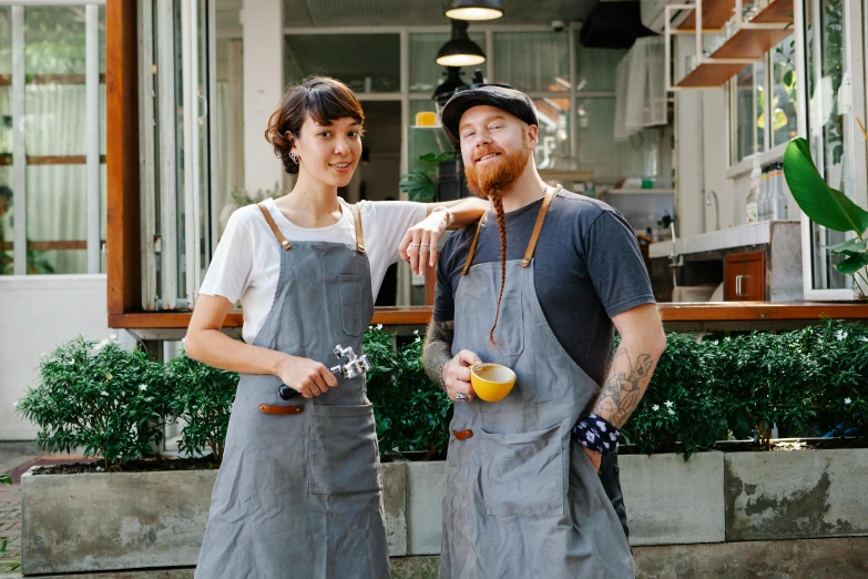 a man and a woman standing next to each other, aussie baristas, blacksmith apron, thumbnail, jordan grimmer and james jean