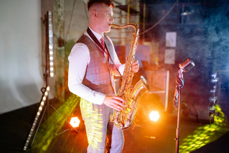 a man in a vest playing a saxophone, by Joe Bowler, happening, industrial party, paisley, thumbnail, 15081959 21121991 01012000 4k