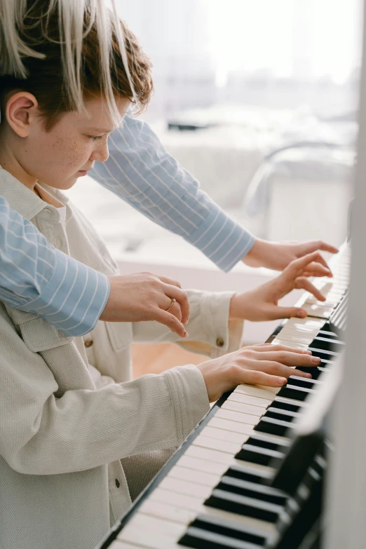 a woman and a child playing a piano, an album cover, pexels, american barbizon school, using synthesizer, private school, white, scientific study