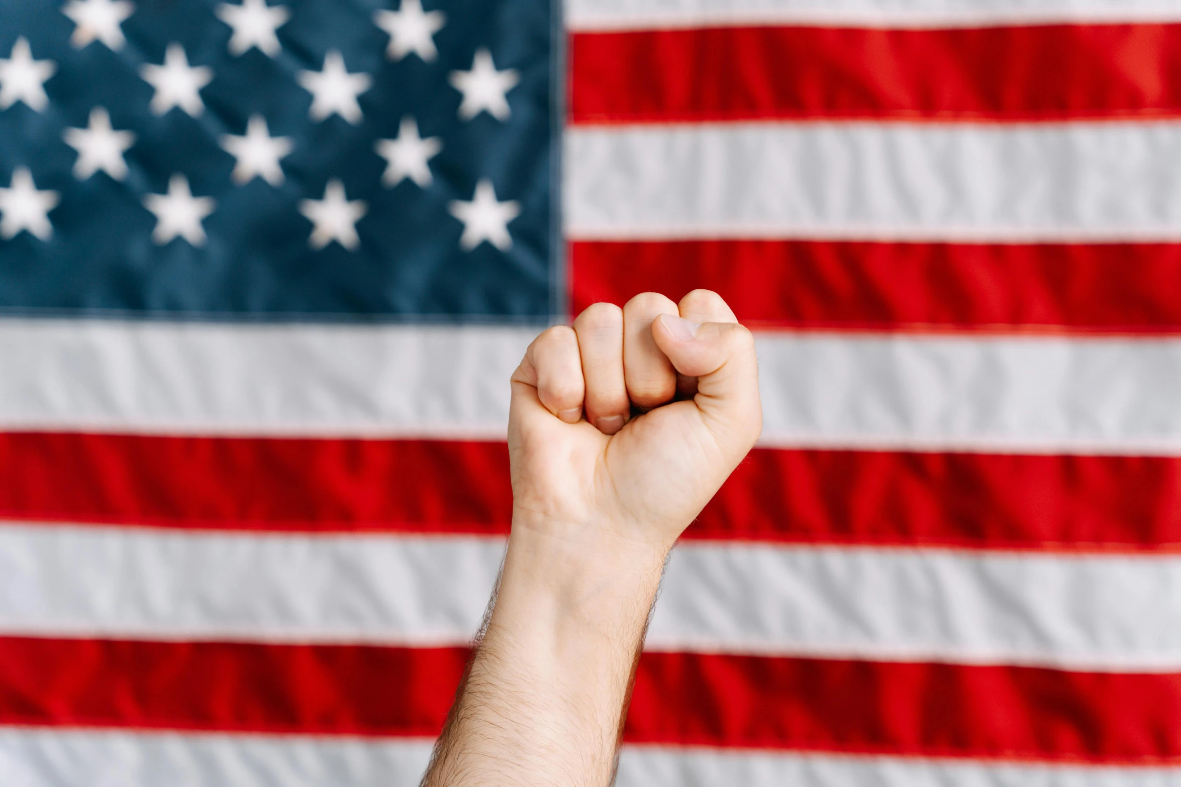 a fist in front of an american flag, a picture, avatar image, background image, instagram post, american man