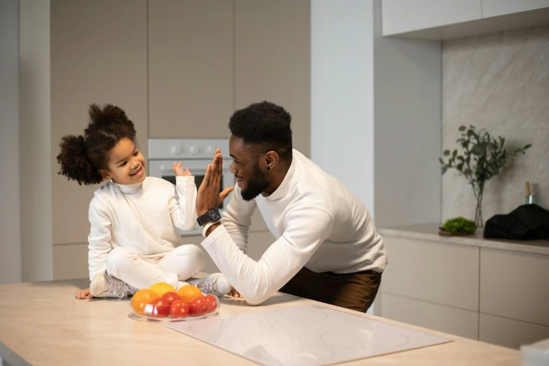 a man and a little girl sitting on a kitchen counter, pexels contest winner, symbolism, black people, greeting hand on head, 1 4 9 3, tastes