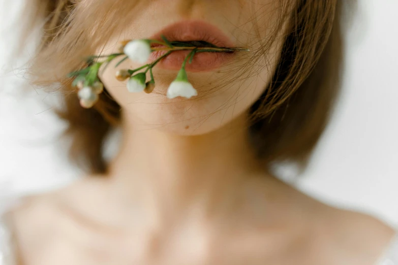 a woman with a flower in her mouth, inspired by Elsa Bleda, trending on pexels, pale thin lips, with soft bushes, half body photo, neck zoomed in from lips down