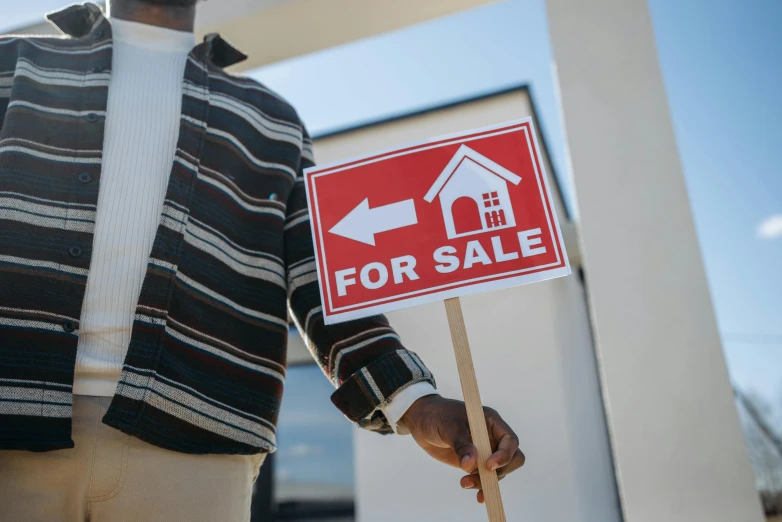 a man holding a for sale sign in front of a house, trending on unsplash, holding a cane, square, exploration, pictured from the shoulders up