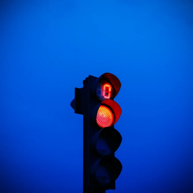 a close up of a traffic light with a blue sky in the background, an album cover, by Adam Marczyński, unsplash, postminimalism, midnight-blue, square, volumetric lighting. red, cold color