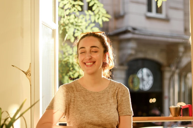 a woman sitting at a table with a plate of food, at golden hour, profile image, mutahar laughing, portrait image