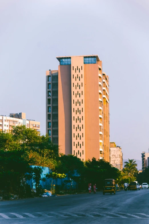 a couple of tall buildings sitting on the side of a road, unsplash, bengal school of art, panoramic view, near the beach, exterior view, 90s photo