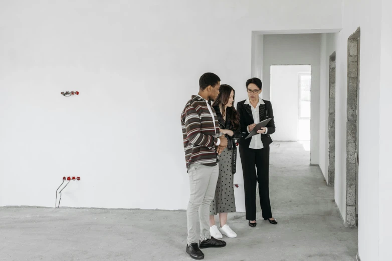 a group of people standing in an empty room, developers, white wall complex, profile image, apartment