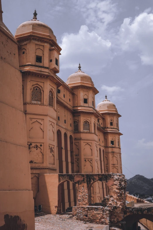 a horse that is standing in front of a building, unsplash contest winner, renaissance, indian temple, built on a steep hill, pink and gold color scheme, ochre