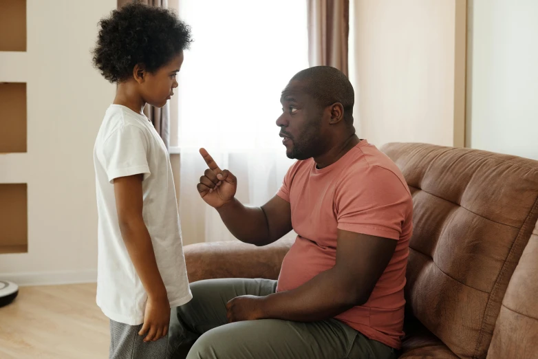 a man and a child sitting on a couch, pexels, hurufiyya, arguing, man is with black skin, standing up, brown:-2