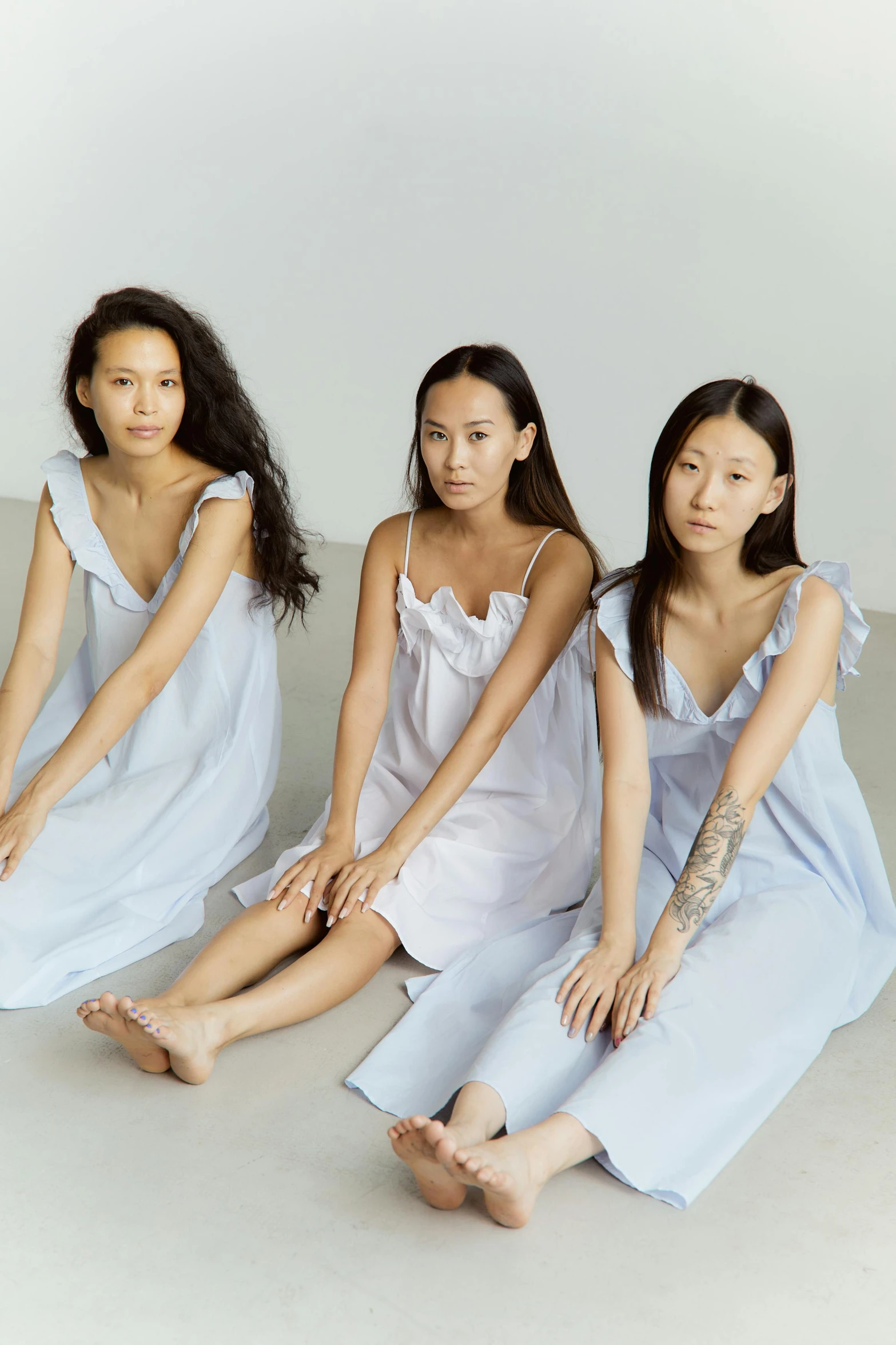 a group of women sitting next to each other, inspired by Kim Tschang Yeul, wearing a nightgown, pale blue, collection product, bedhead