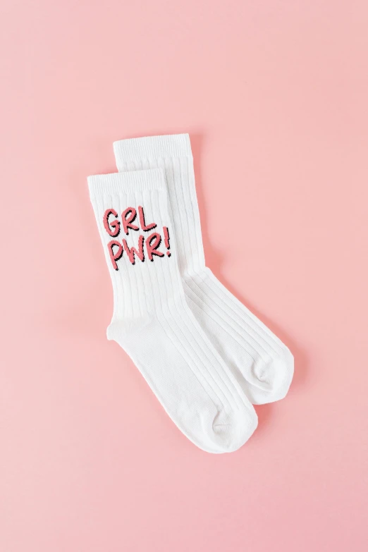 a pair of white socks on a pink background, by Julia Pishtar, instagram, graffiti, official product photo, happy girl, trendy typography, pbr