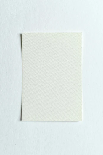 a piece of paper sitting on top of a white surface, a picture, cream white background, single color, rectangle, whole card
