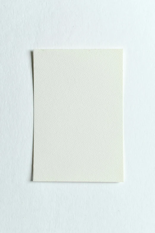 a piece of paper sitting on top of a white surface, a picture, cream white background, single color, rectangle, whole card