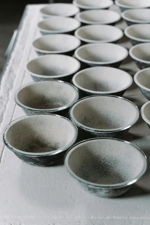 a bunch of bowls sitting on top of a table, blackening effect, smooth tiny details, foam, ready to eat