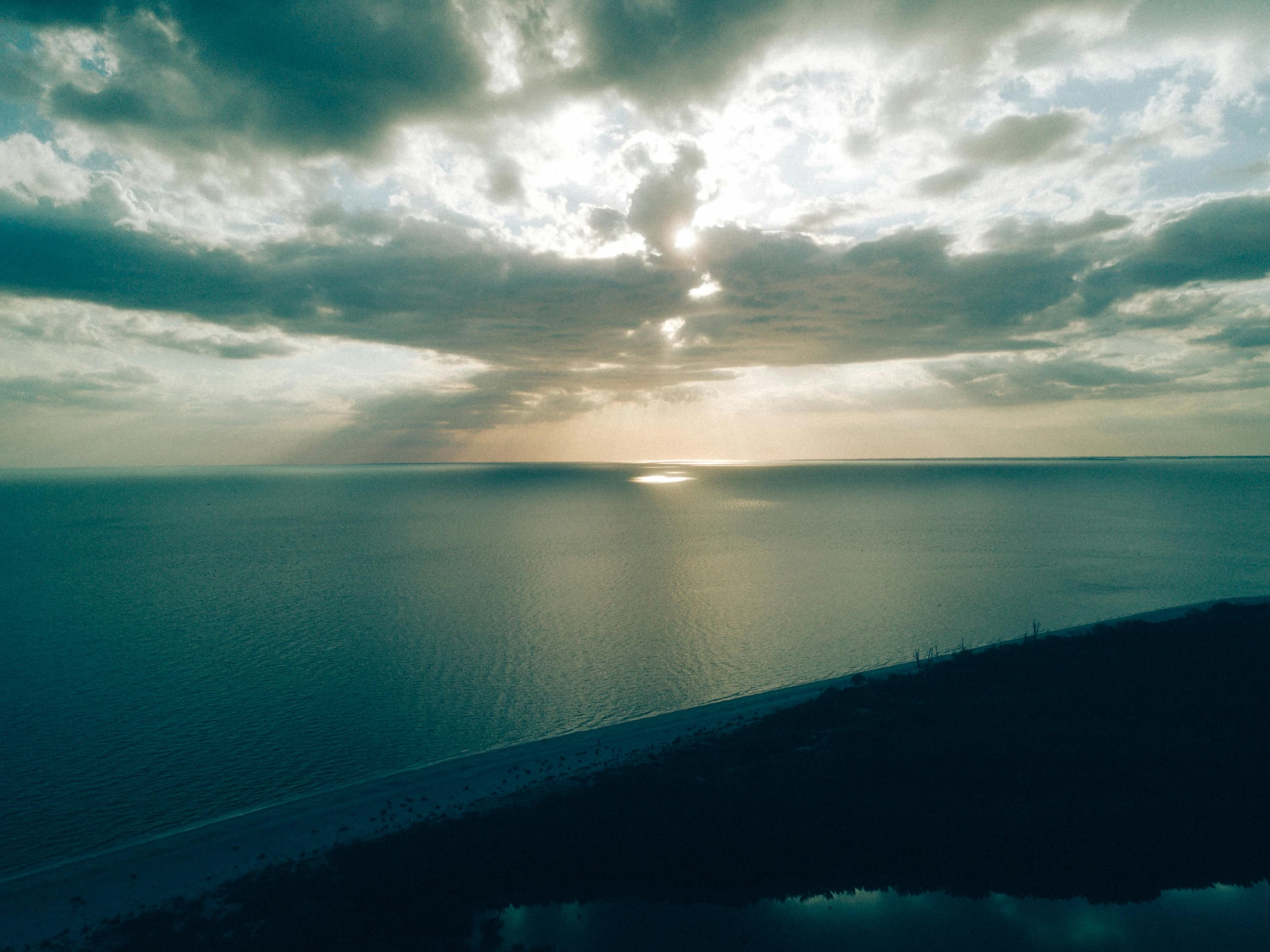 a large body of water under a cloudy sky, a picture, unsplash contest winner, romanticism, overhead sun, seaview, slide show, cinematic 8 k