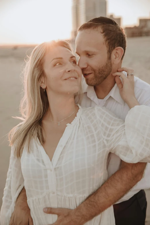 a man and woman standing next to each other on a beach, by Gwen Barnard, unsplash, renaissance, soft sun lights, wearing a linen shirt, close up portrait photo, white