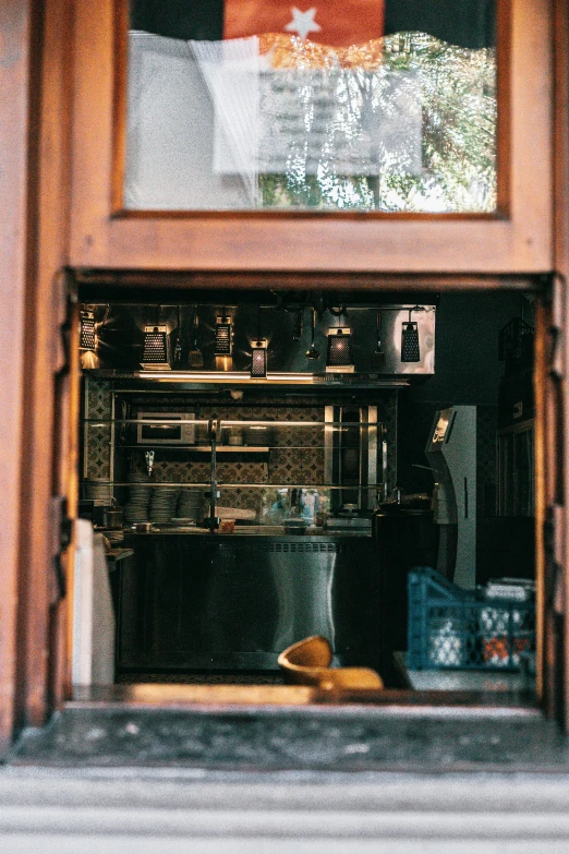 a view of a coffee shop through a window, pexels contest winner, renaissance, server in the middle, cabinets, small kitchen, moroccan