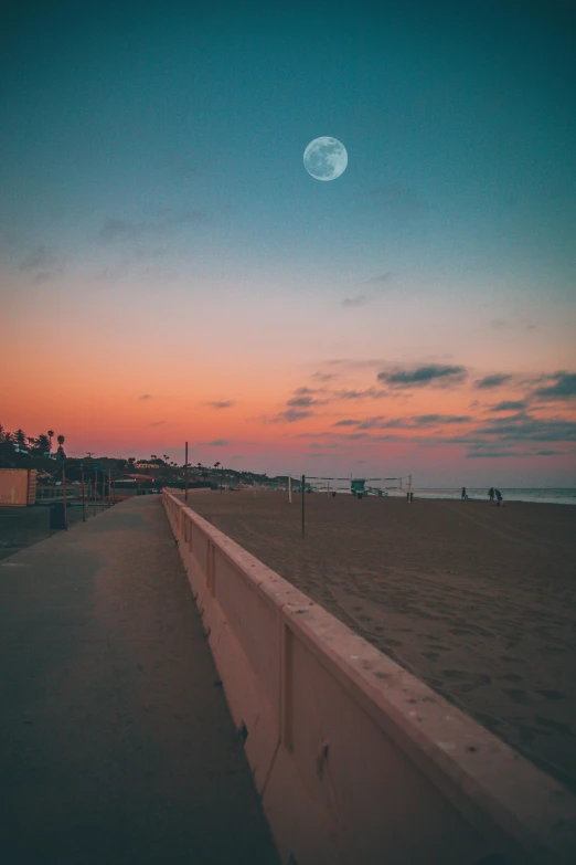 a beach at sunset with a full moon in the sky, by Niko Henrichon, unsplash contest winner, aestheticism, city street on the moon, southern california, profile image, sandy white moon landscape