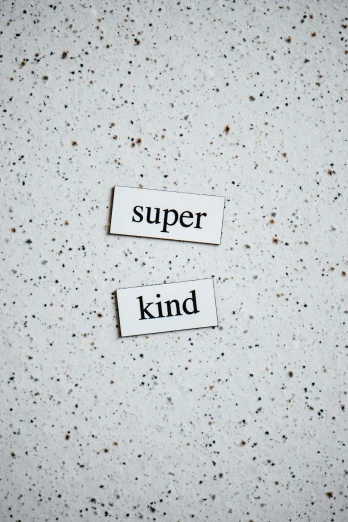 a piece of paper with the words super kind on it, by Jesper Knudsen, trending on unsplash, superflat, made out of shiny white metal, 15081959 21121991 01012000 4k, panel, grey
