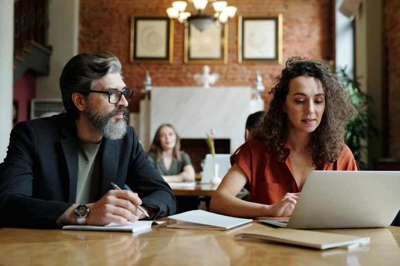 a man and a woman sitting at a table with a laptop, profile image, curated collections, thumbnail, unblur