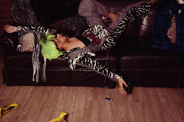 a woman laying on top of a couch next to a banana, inspired by Elsa Bleda, maximalism, glam rockers drinking wine, wearing disco suit, daido moriyama, cai xukun