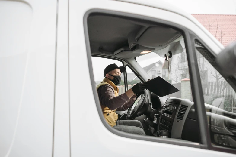 a man sitting in the drivers seat of a truck, pexels contest winner, delivering mail, avatar image, worksafe. instagram photo, no - text no - logo