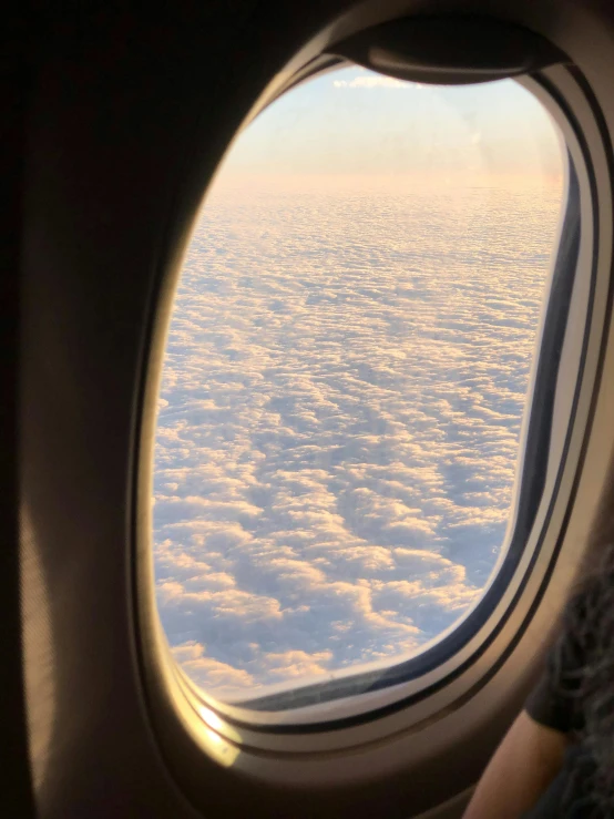 a woman looks out the window of an airplane, by Anna Haifisch, ☁🌪🌙👩🏾, photo of a beautiful window, partly cloudy, airing in 2 0 2 3