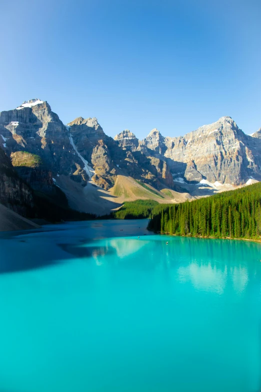 a large body of water surrounded by mountains, by Daniel Seghers, pexels contest winner, banff national park, cool colors, summer morning light, mountains of ice cream