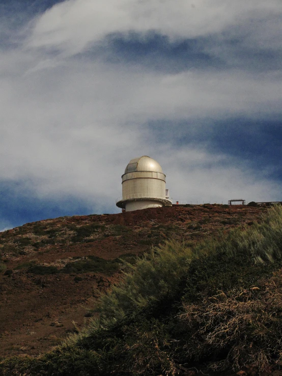 a white lighthouse sitting on top of a hill, space telescope, taken on a 2000s camera, brown, thumbnail