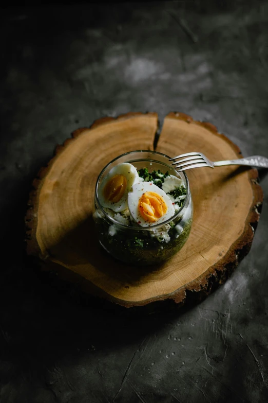 a close up of a plate of food on a table, a picture, unsplash, eggs, on a wooden plate, 27, #green