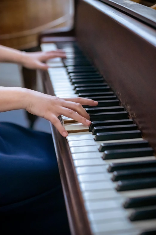 a close up of a person playing a piano, louise zhang, schools, brown, blues